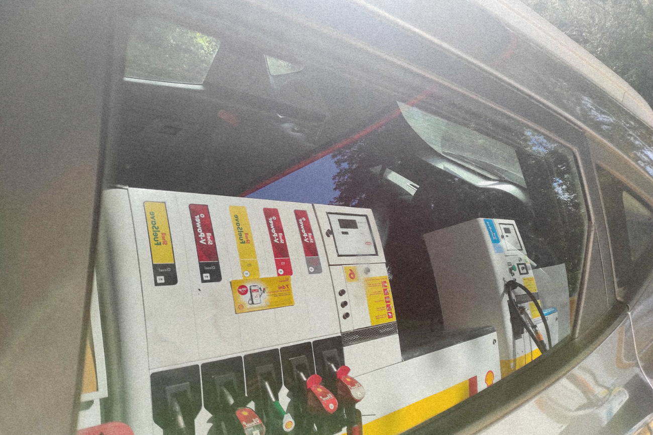 Dystrybutor w odbiciu samochodu.