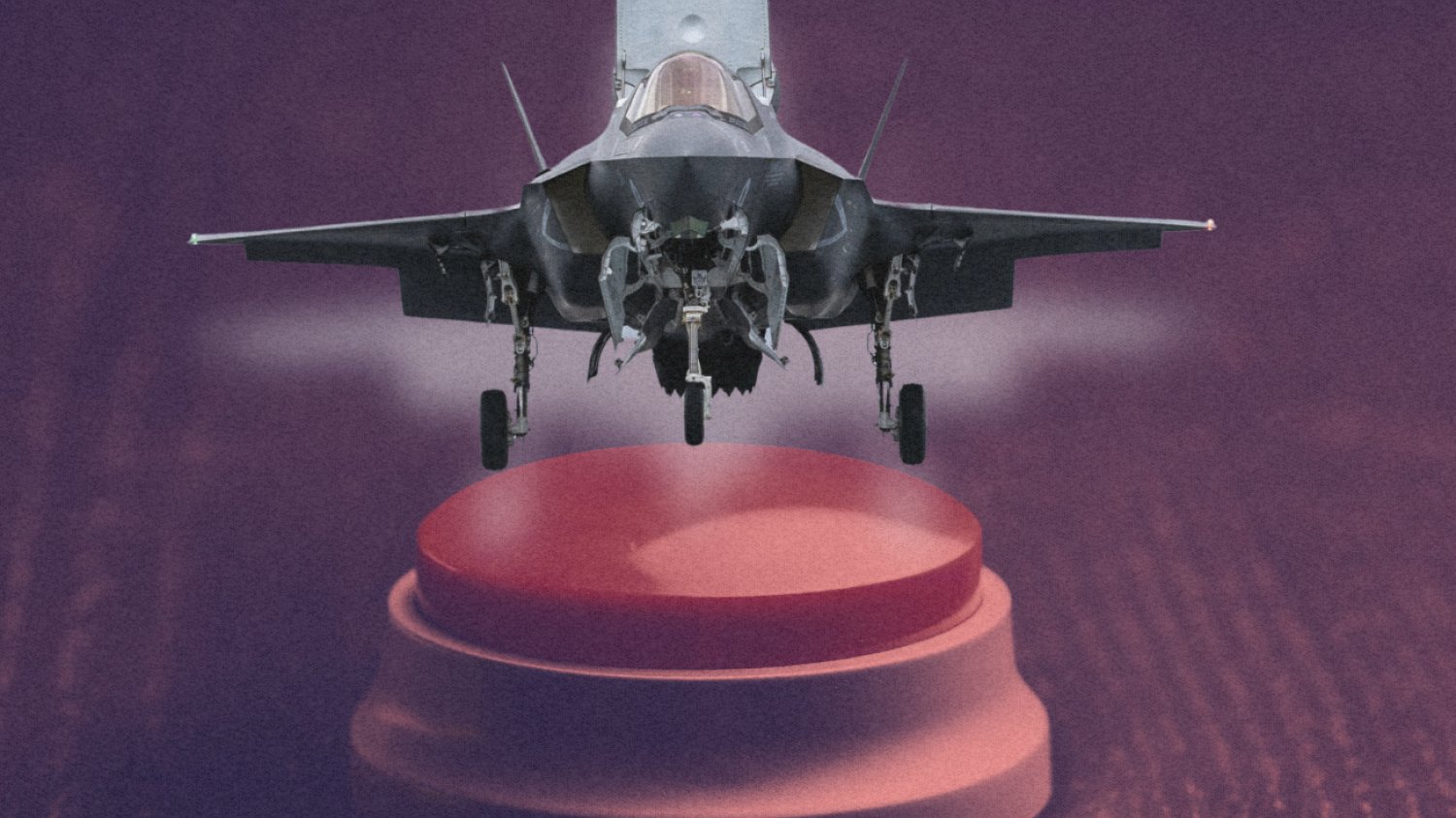 F-35 lądujący na dużym czerwonym przycisku.