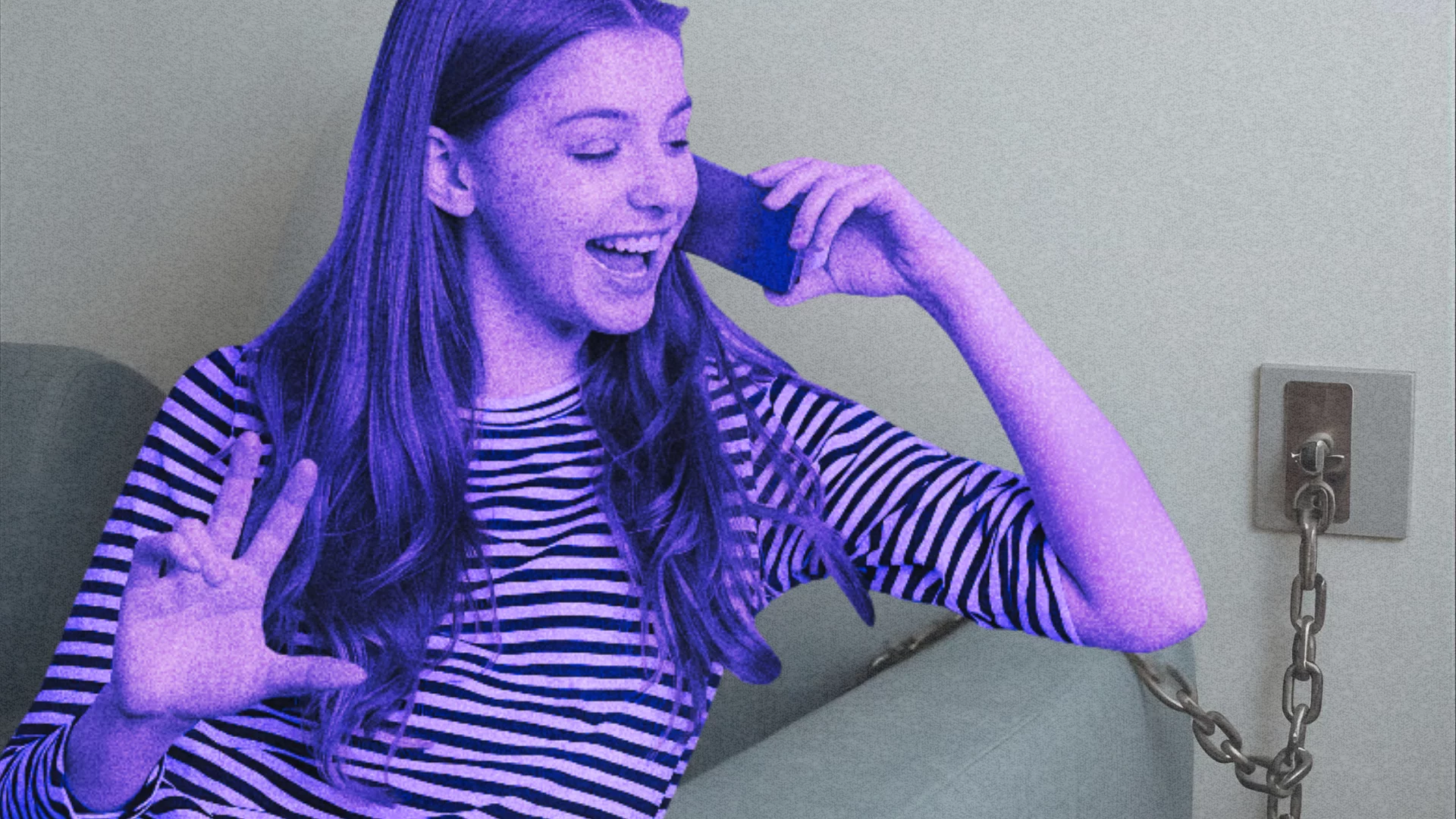 Dziewczyna rozmawia przez smartfon, który przykuty jest łańcuchem do ściany. Zetki mają nowy sposób na uzależnienie od smartfonów