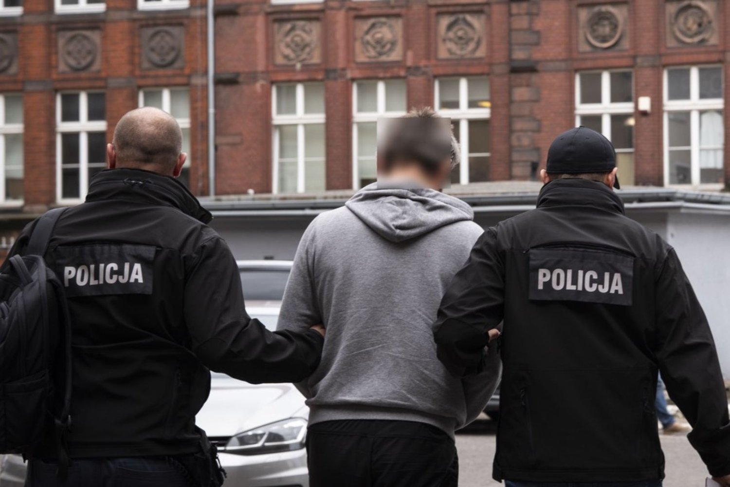 Policjanci z aresztowanym mężczyzną.