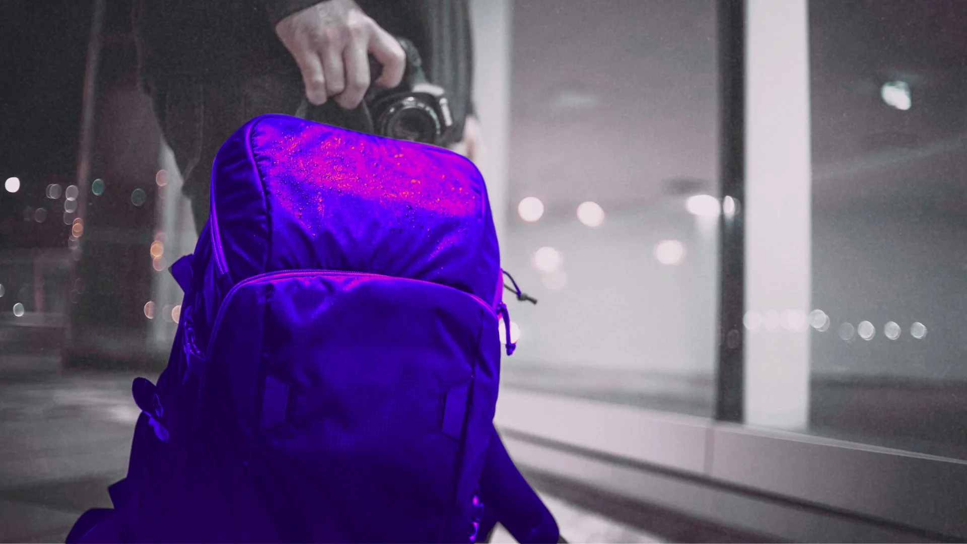 Osoba trzyma w ręce plecak.