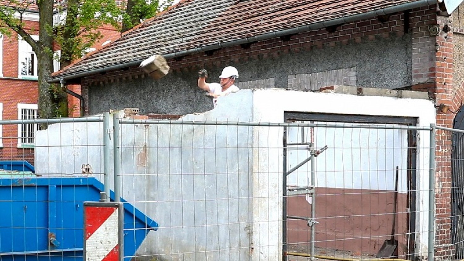 Burmistrz Lublińca samodzielnie przeprowadza rozbiórkę garażu przed urzędem miasta.