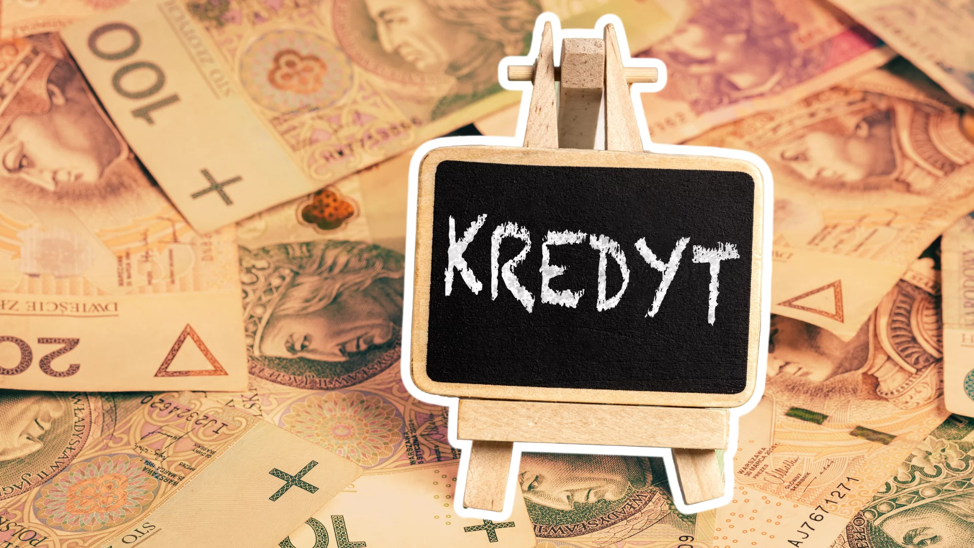 Rozrzucone pieniądze. Z przodu tabliczka z napisem kredyt.