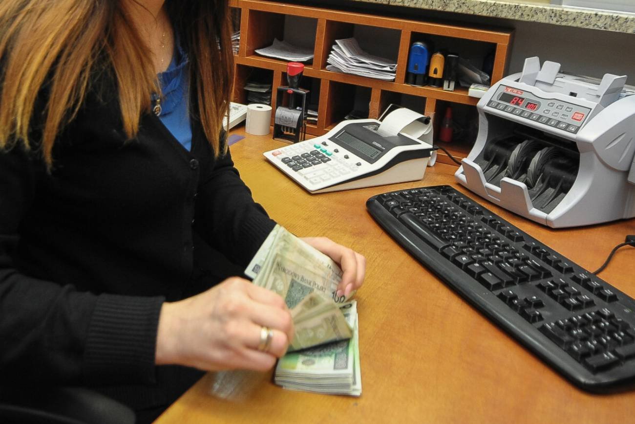 Pracownica banku przeliczająca pieniądze