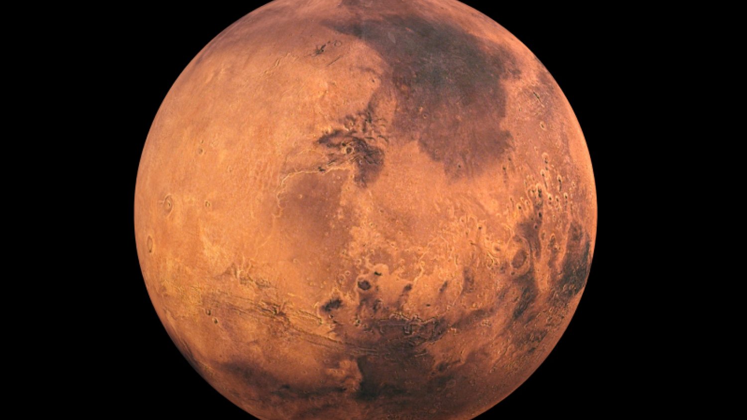 Mars na tle czarnej przestrzeni kosmicznej. Na północym biegunie planety widoczna jest pokrywa lodowa.