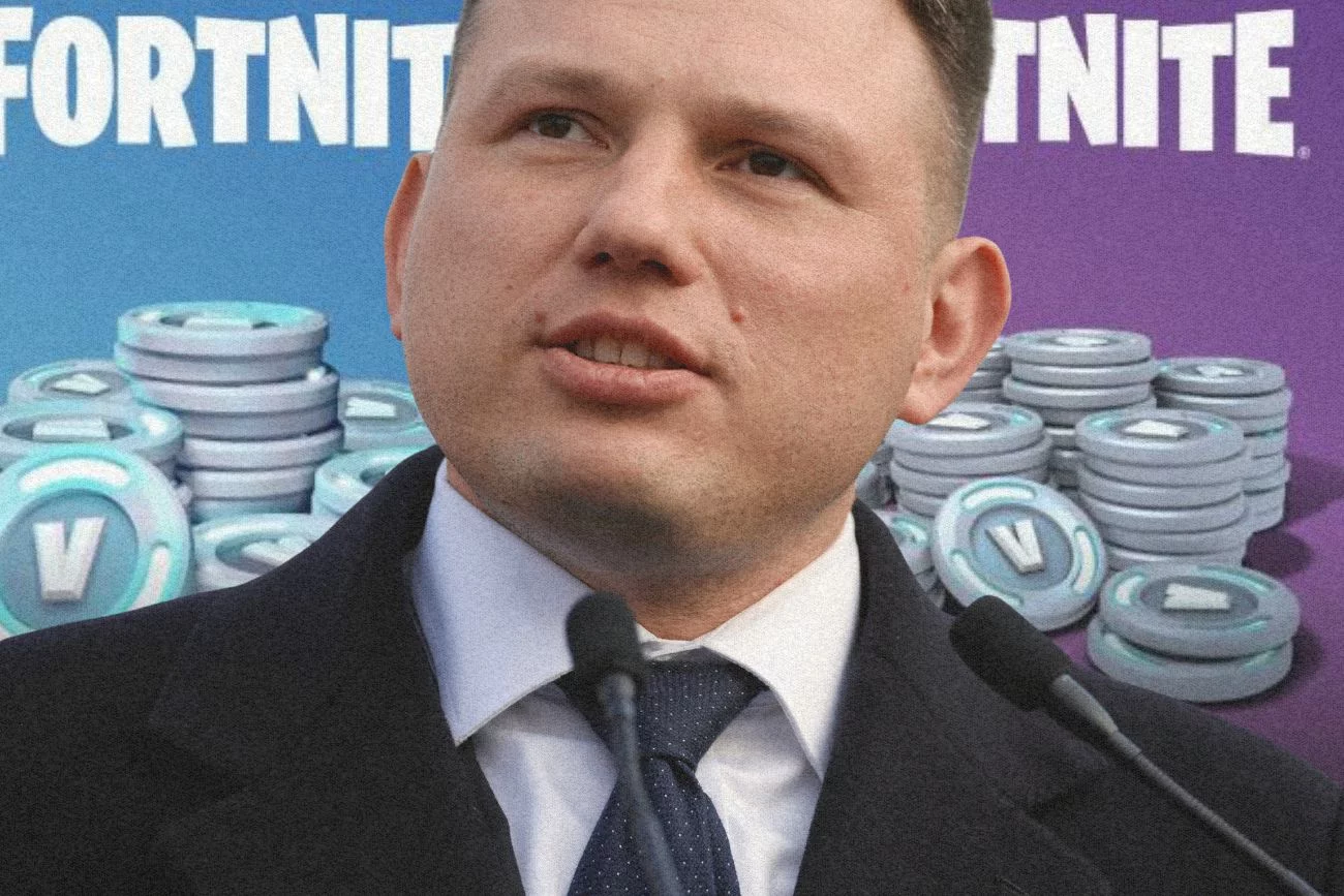 Sławomir Mentzen na tle sklepu z v-dolcami.