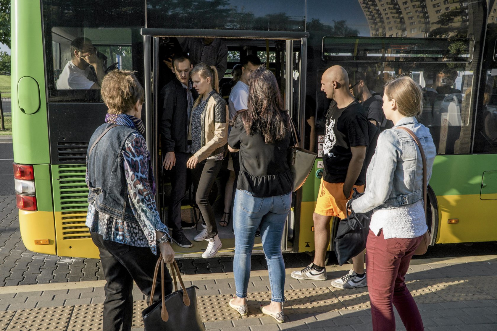 Ludzie wchodzący do autobusu.