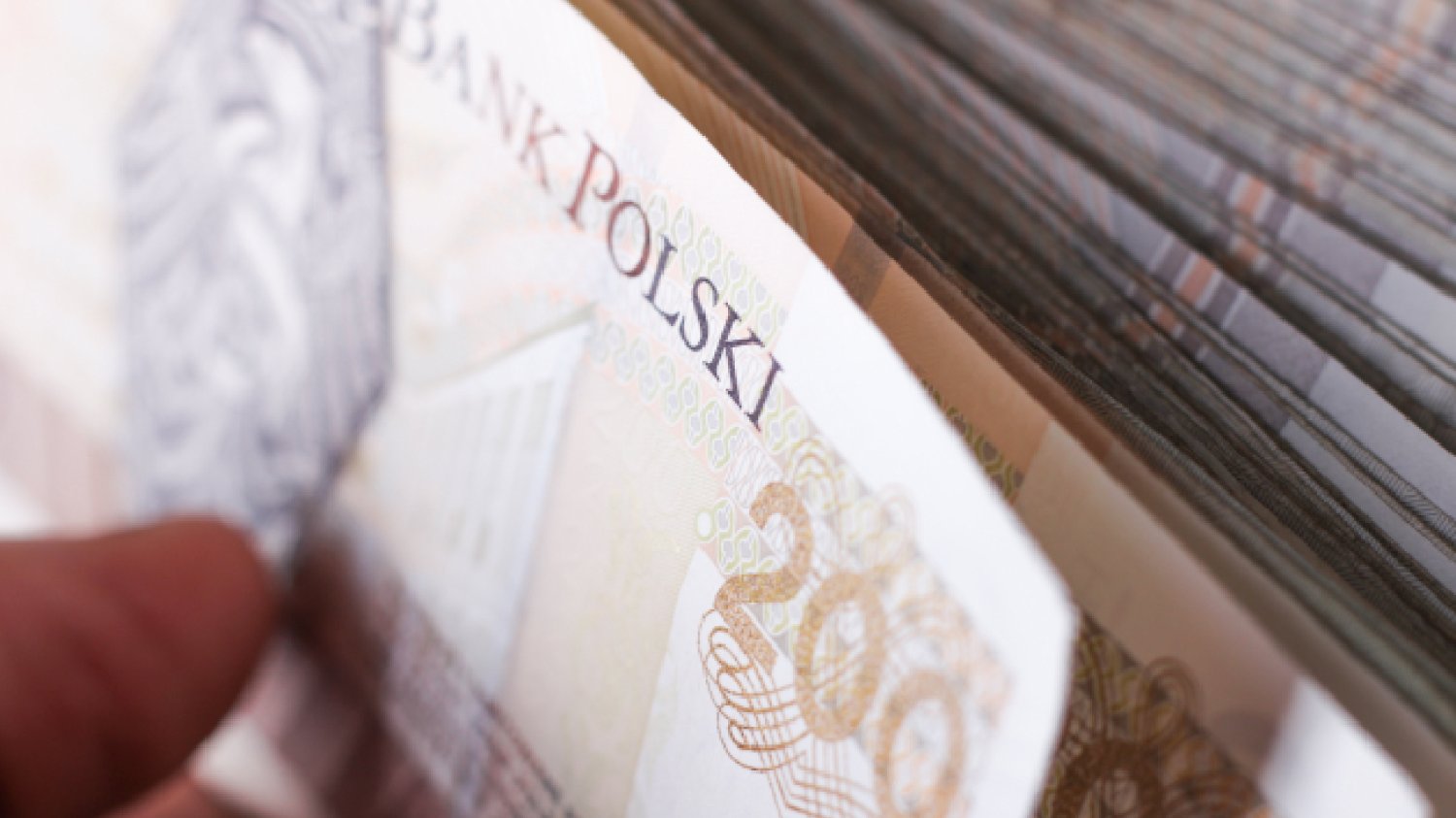polskie banknoty dwieście złotych w ręku mężczyzny