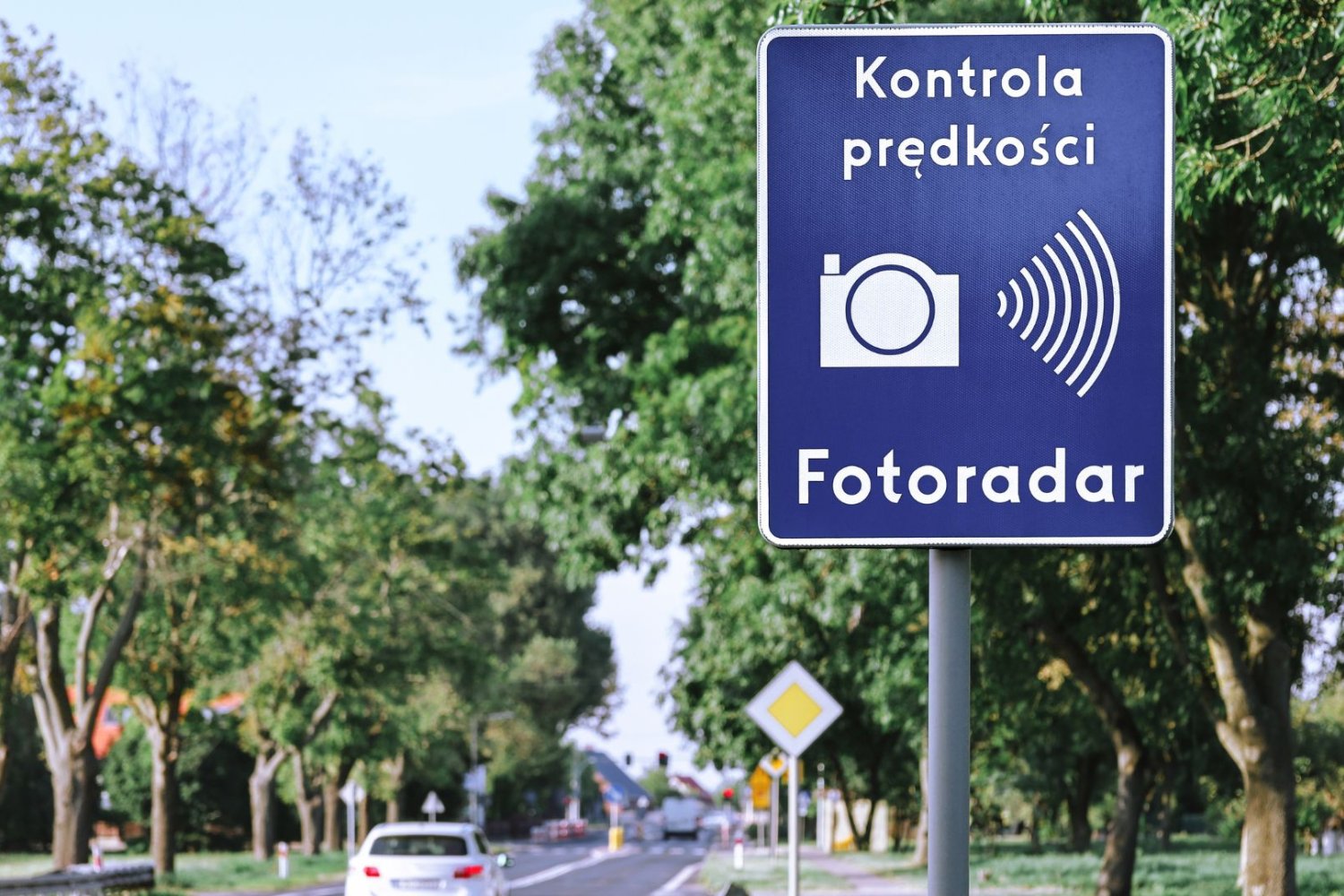 Znak przy drodze informujący o kontroli fotoradaru.