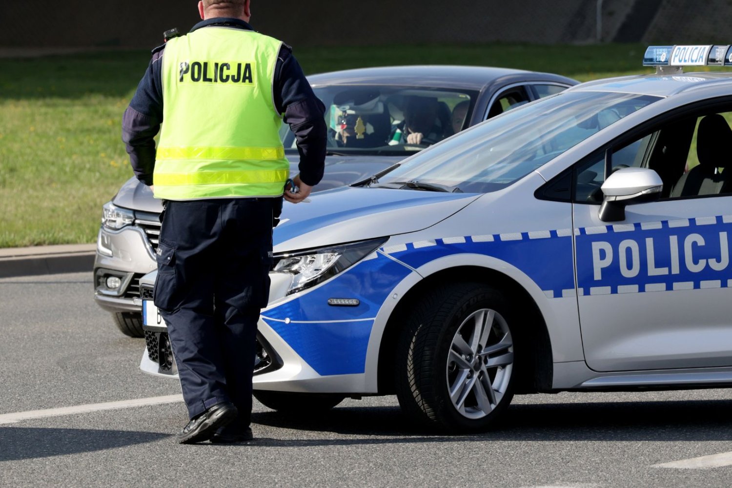 Policjant obok radiowozu