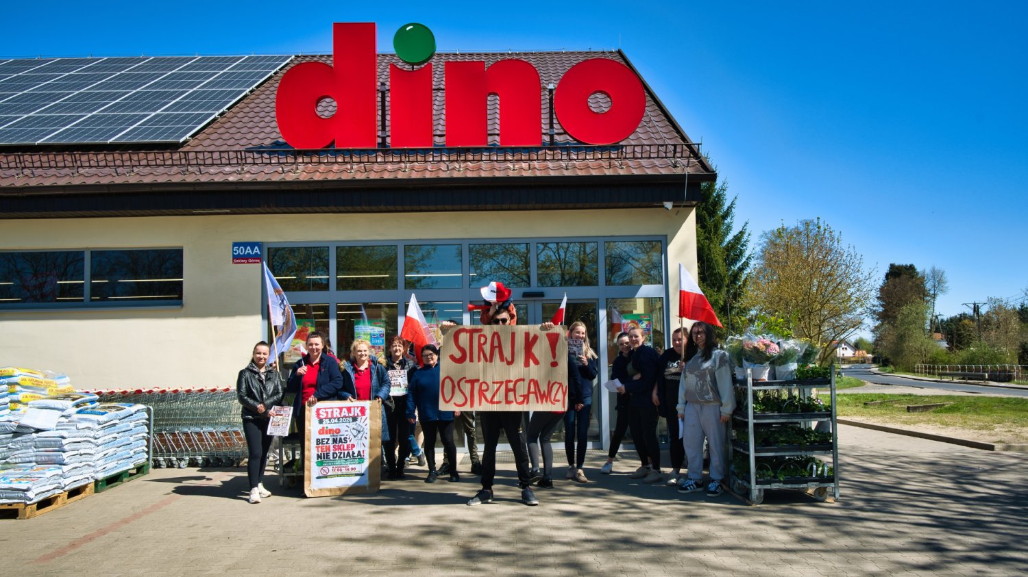 Kurs akcji Dino rośnie. W tle ostry spór ze związkowcami. sklep dino i strajkujący pracownicy